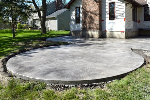 New concrete patio attached to white house
