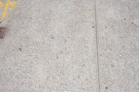 Exposed aggregate concrete walkway texture