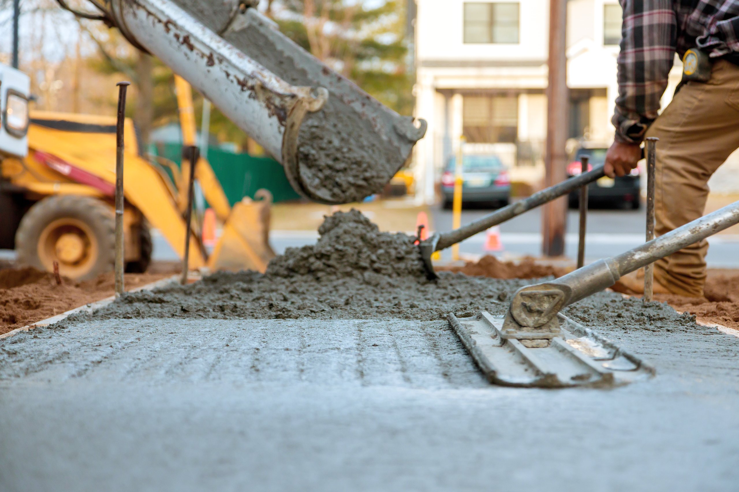 Workers pouring fresh concrete for a construction project