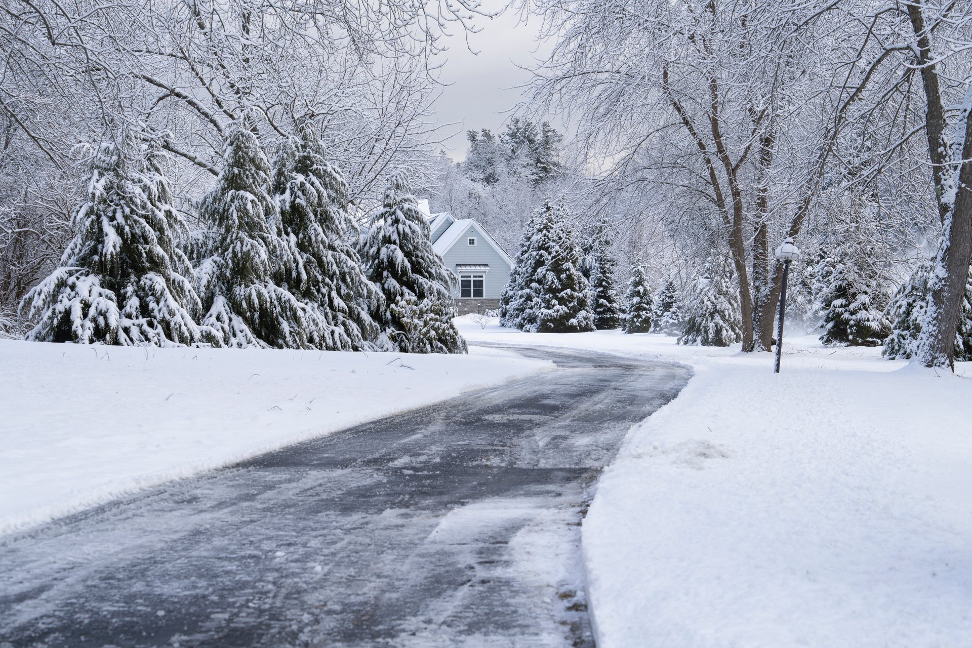 House and driveway covered in snow after winter storm