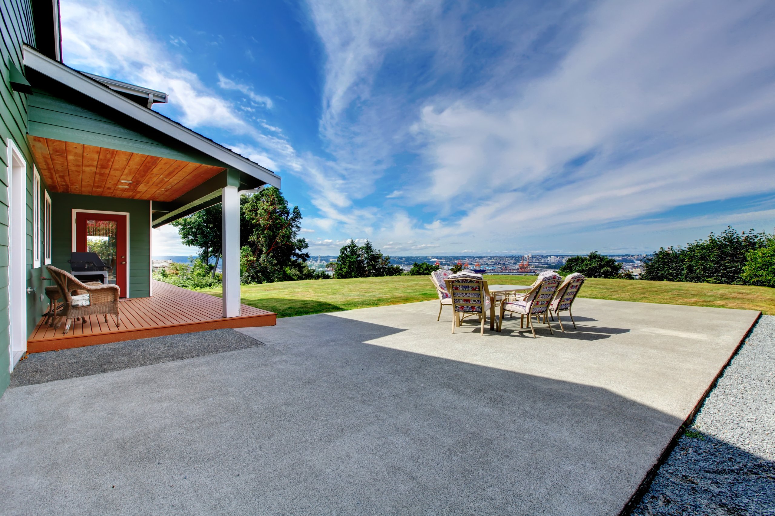 Large concrete patio area with outdoor furniture