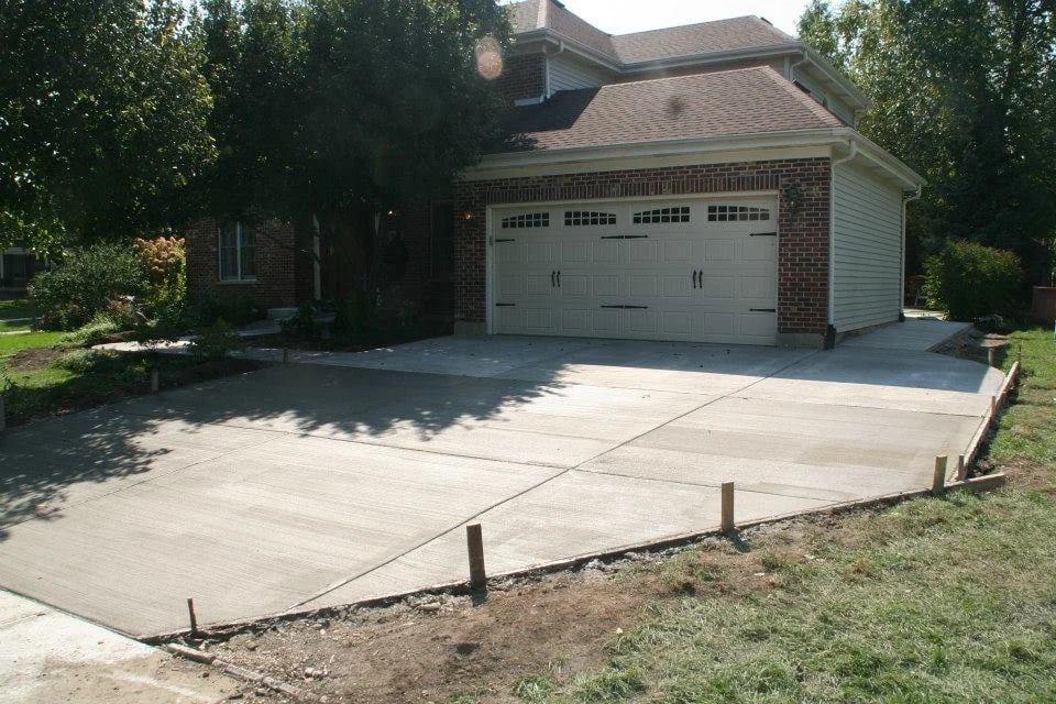 Modern home with large driveway at sunset